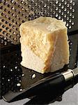 Piece of parmesan and grater