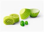 Green rolled candies and paper cups