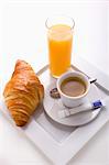 Breakfast with coffee,croissant and a glass of orange juice