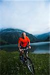 Mature Man Riding Mountain Bike by Vilsalpsee, Tannheim Valley, Tyrol, Austria