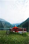 Mature Man on Bench by Lake with Mountain Bike, Vilsalpsee, Tannheim Valley, Tyrol, Austria