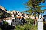 Europe, Bulgaria, Melnik, statue and houses in a sandstone landscape