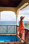 Dominica, Calibishie. A young woman admires the view from the Penthouse at Calibishie Cove. (MR).