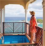 Dominica, Calibishie. A young woman admires the view from the Penthouse at Calibishie Cove. (MR).