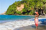 Dominica, Calibishie. A young woman looks out to sea at Batibou Beach. (MR).