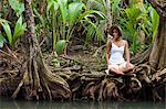 Dominica, Portsmouth. A young woman sits by the Indian River, one of Dominica's most popular tourist attractions. (MR).