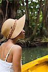 Dominica, Portsmouth. A young woman sits on a boat on the Indian River, one of Dominica's most popular tourist attractions. (MR).