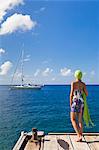 Dominica, Roseau. A young woman looks out to sea near Roseau. (MR).