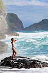 Dominica, Riviere Cyrique. A young woman stands under the waterfall at Wavine Cyrique. (MR).