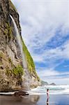 Dominica, Riviere Cyrique. A young woman stands looking at the waterfall at Wavine Cyrique. (MR).