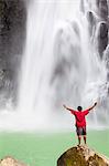 Dominica, Delices. A man stands at the base of Victoria Falls, one of the tallest and most spectacular waterfalls on Dominica. (MR).