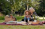 Nottinghamshire, UK. Grandmother and toddler enjoy a late summer family picnic. (MR)