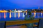 Iceland, Reykjavik, Lake Tjornin, statue of a man on a bench