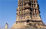 Asia, India, Madhya Pradesh, Khajuraho.  Chaturbhuja temple, eastern group.  An Indian family admire the sculptures on the temple.