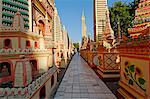 Myanmar, Burma, Sagaing Region, Monywa. Built in 1939, the Thanboddhay Paya, or temple, near Monywa is famed for its extraordinary array of Buddha statues, large and small, and colourful, almost kisch, decoration that covers its interior and exterior.