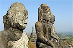 Myanmar, Burma, Rakhine State, Mrauk U. A cluster of ancient Buddha statues stand atop a hill overlooking the town of Mrauk U.