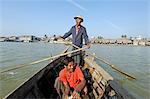 Myanmar, Burma, Rakhine State, Sittwe. A Rohingya youth enjoys betel nut on a rowing boat at Sittwe.