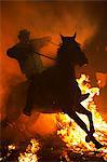 Spain, Castille & Leon, Avila, San Bartolome de Pinares, Men and horses jumping through fire on the eve of the feast of San Antonio, as a tradition to purify the animals.