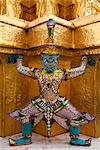 Thailand, Bangkok.  Statue at Wat Phra Kaeo, Temple of the Emerald Buddha, within the grounds of the Royal Grand Palace.