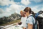 Mature couple looking at map, hiking in mountains, Tannheim Valley, Austria