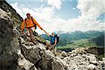 Mature couple hiking in mountains, Tannheim Valley, Austria