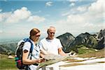 Mature couple looking at map, hiking in mountains, Tannheim Valley, Austria