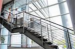 Doctors rushing down hospital staircase, blurred motion