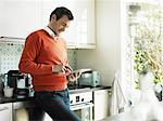 Mature man using tablet in kitchen