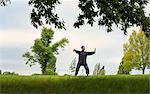 Mature man performing Tai Chi in countryside