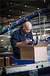 Male warehouse worker using barcode scanner