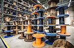 Empty cable drums stacked in warehouse