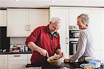 Senior couple baking in kitchen