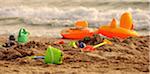 Bucket and spades on sandy beach