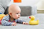 Baby boy staring at rubber duck