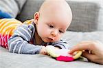 Baby boy staring at toy