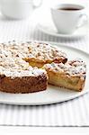 Lemon teacake with slice cut and cup of tea