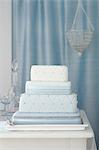 Three tiered wedding cake with blue decorations