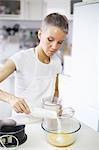 Woman pouring sugar into mixing bowl