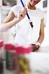 Woman pouring melted chocolate