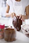 Woman slicing top off cake