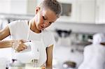 Woman using electric whisk