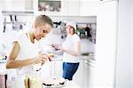 Woman icing cake