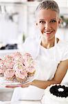 Portrait of woman holding hand made cupcakes