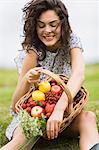 Young woman with a basket full of fruits