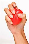 Woman's hand holding red plastic heart