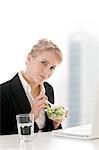 Businesswoman eating at desk