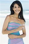 Brown-haired young woman on the beach, summer