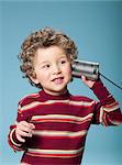 Boy using tin can as a phone