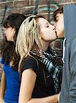 Teenagers kissing near teenage girl