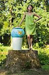 Young woman throwing globe into dustbin